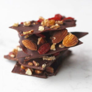 A stack of chocolate bark with nuts and dried fruit.