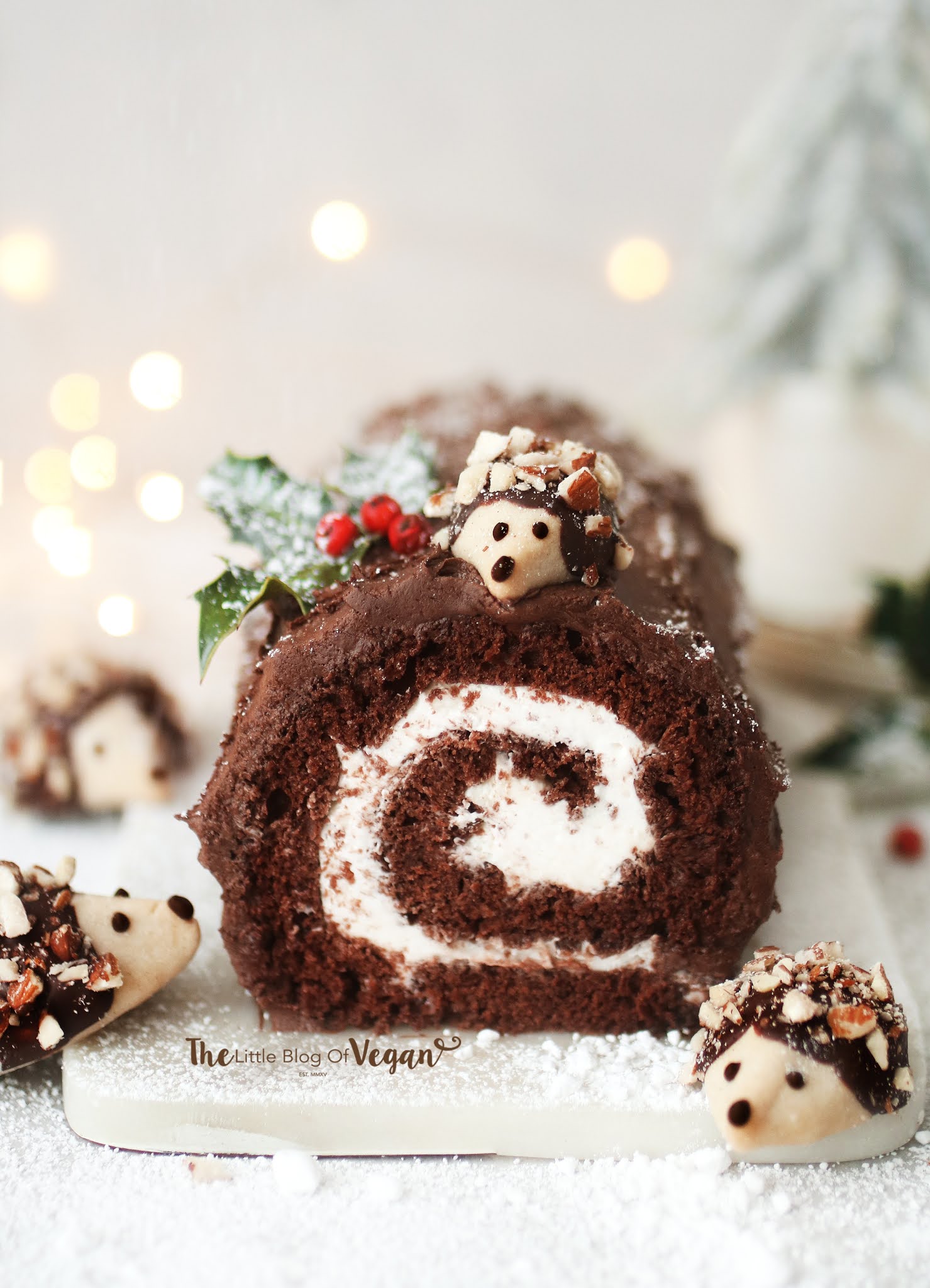 A vegan chocolate roll with holiday hedgehogs on it.