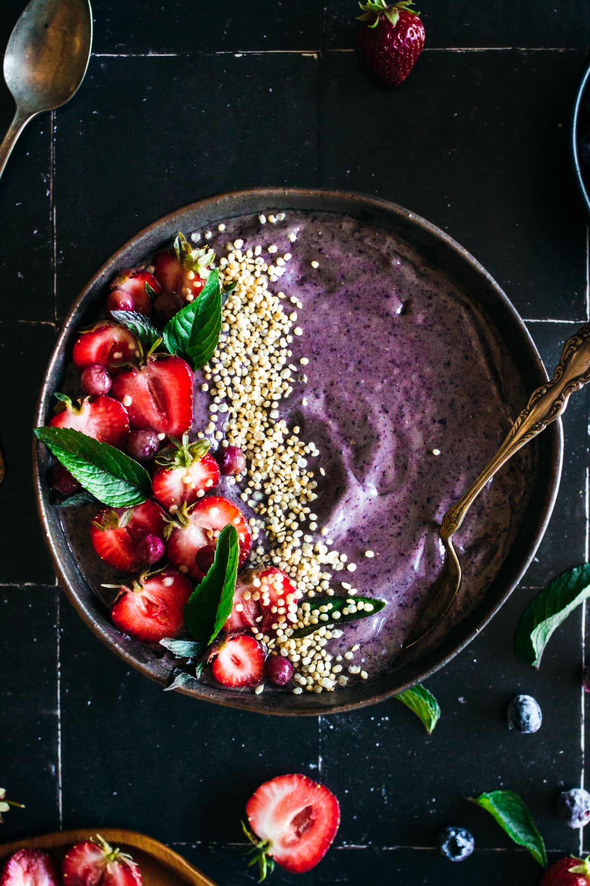 Up close blueberry smoothie bowl made with bananas, acai, and almond butter.