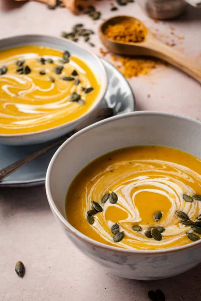 Angled photo of two bowls of butternut squash soup