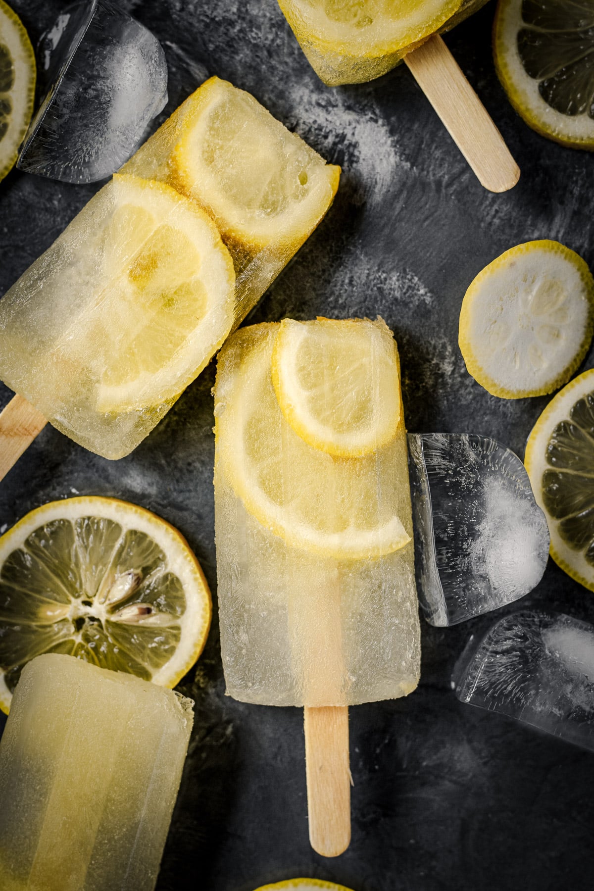 Close up of lemon popsicles with fresh slices of lemon.