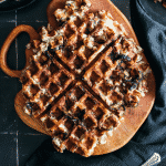 Large potato waffle on a wooden board.