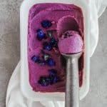 Close up of purple sweet potato ice cream with a scoop taken out.
