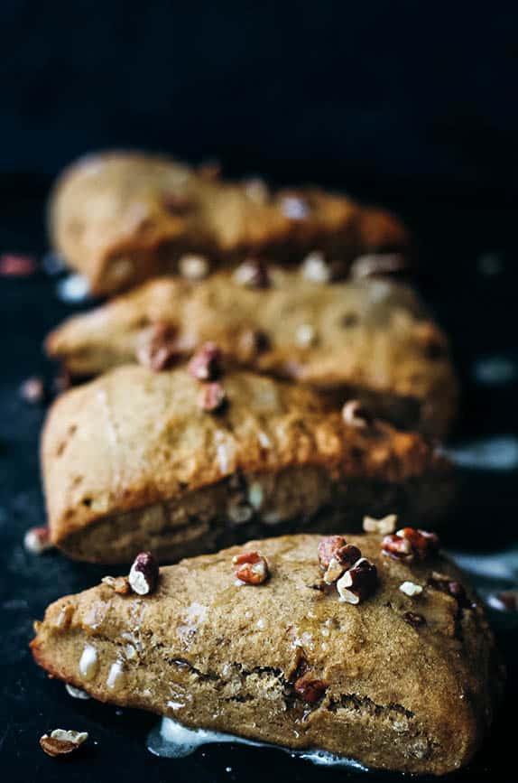 Photo of banana nut scones with a black background. 