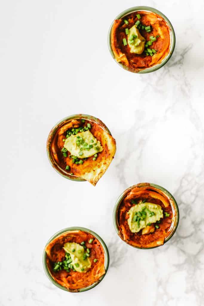 Four easy vegan lasagnas in green enamel cups.