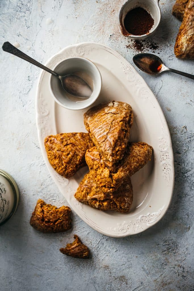 Pumpkin scones on an oval white plate.