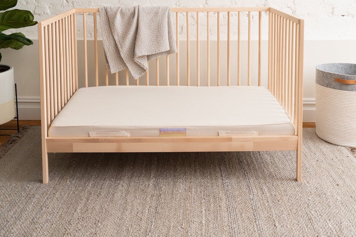 Organic crib mattress in a neutral room.