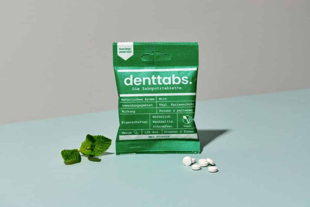 Compostable green package with zero-waste toothpaste tablets.