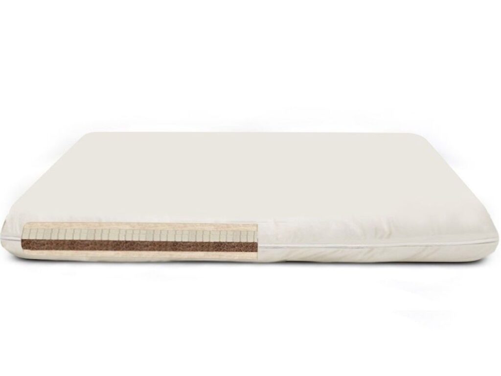 Natural cream colored crib mattress with coconut core showing.