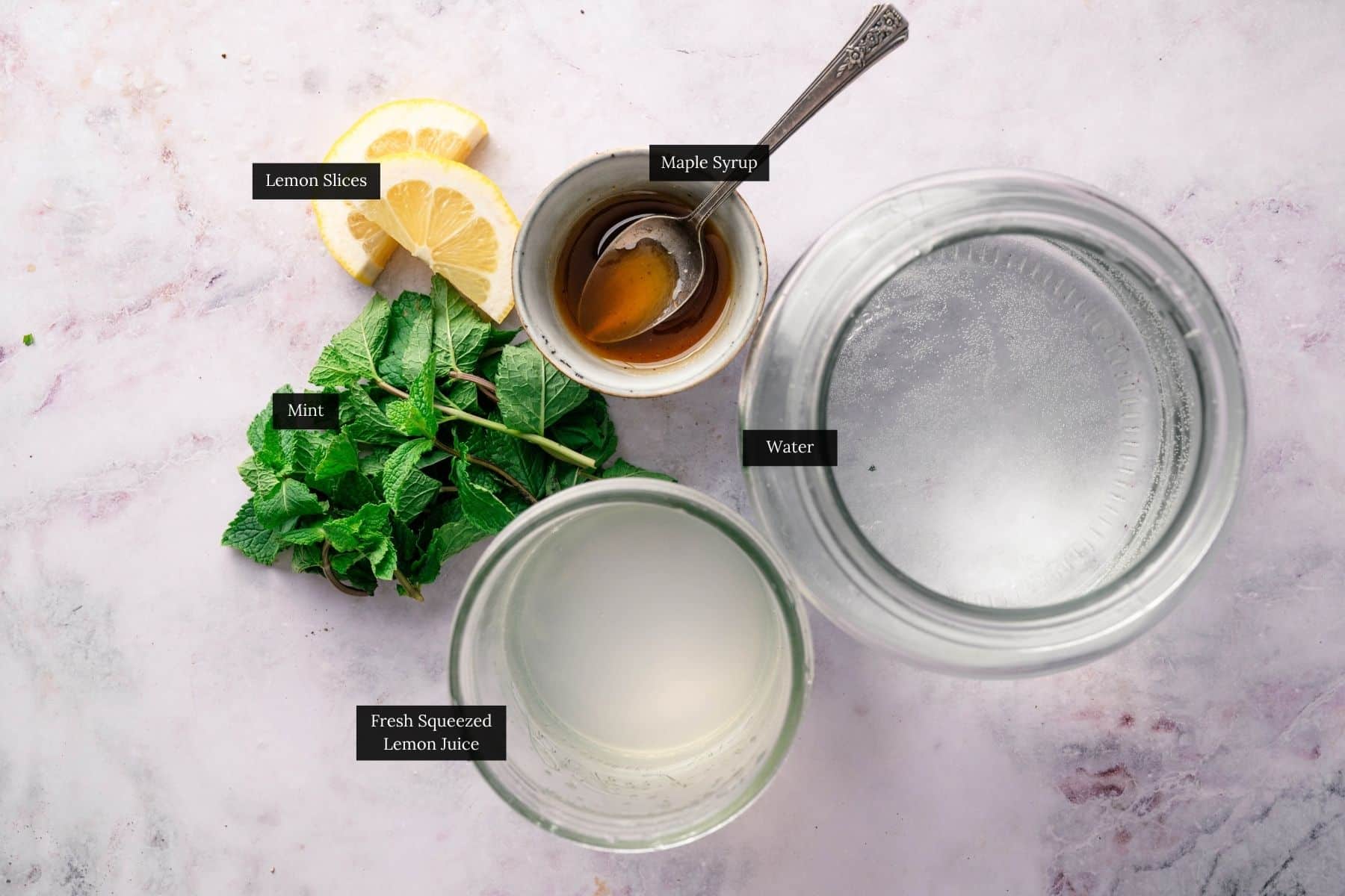Ingredients for homemade lemonade sweetened with maple syrup.