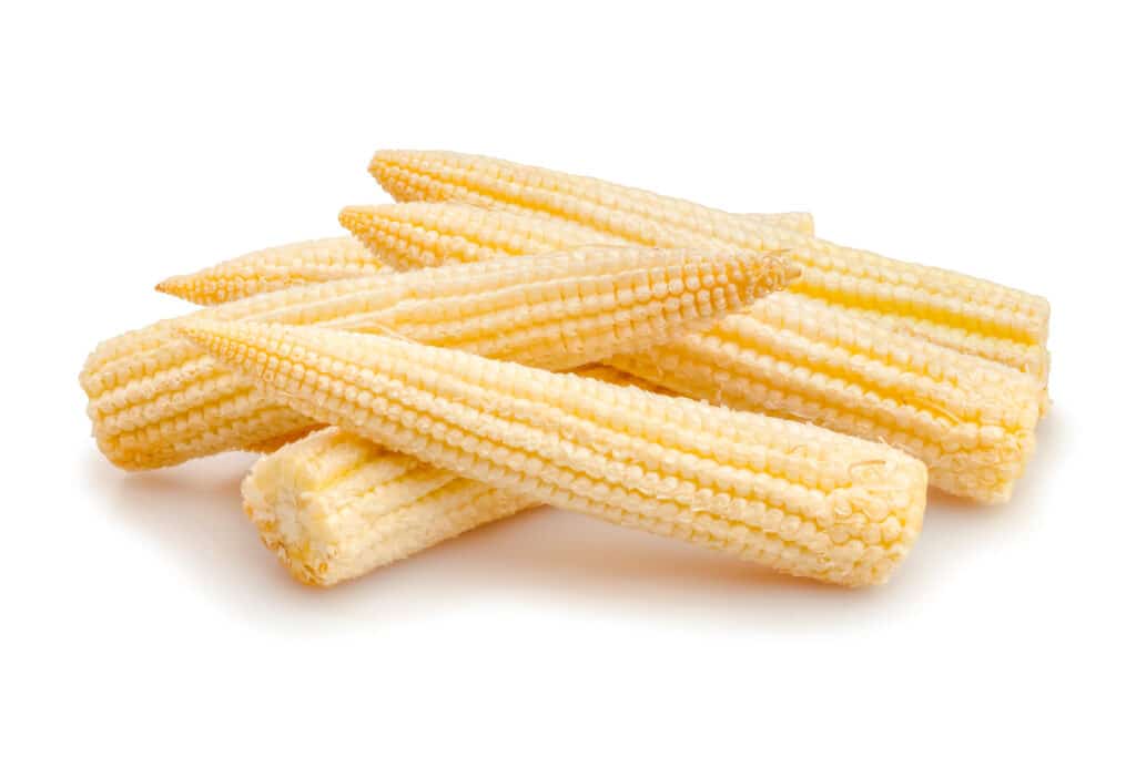 Small pile of creamy yellow mini corn.