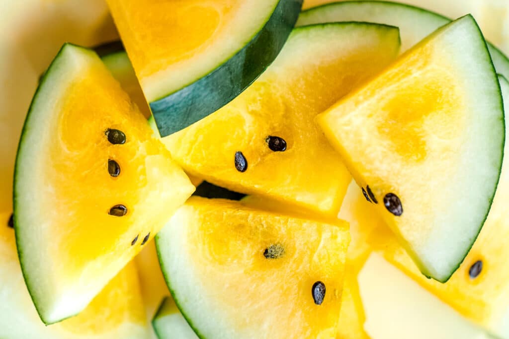 Triangle slices of yellow watermelon.