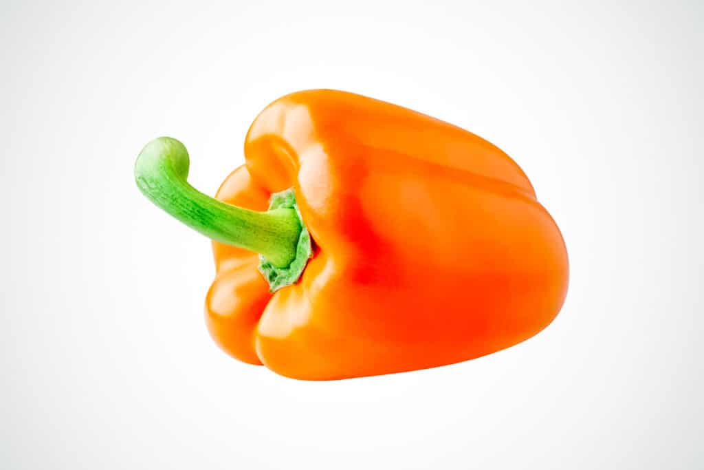 Orange bell pepper with a green stem.