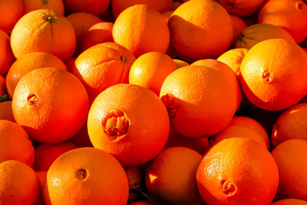 Large pile of navel oranges.
