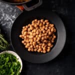 Cooking chickpeas is easy, here is a photo of cooked garbanzo beans with fresh herbs on the side.