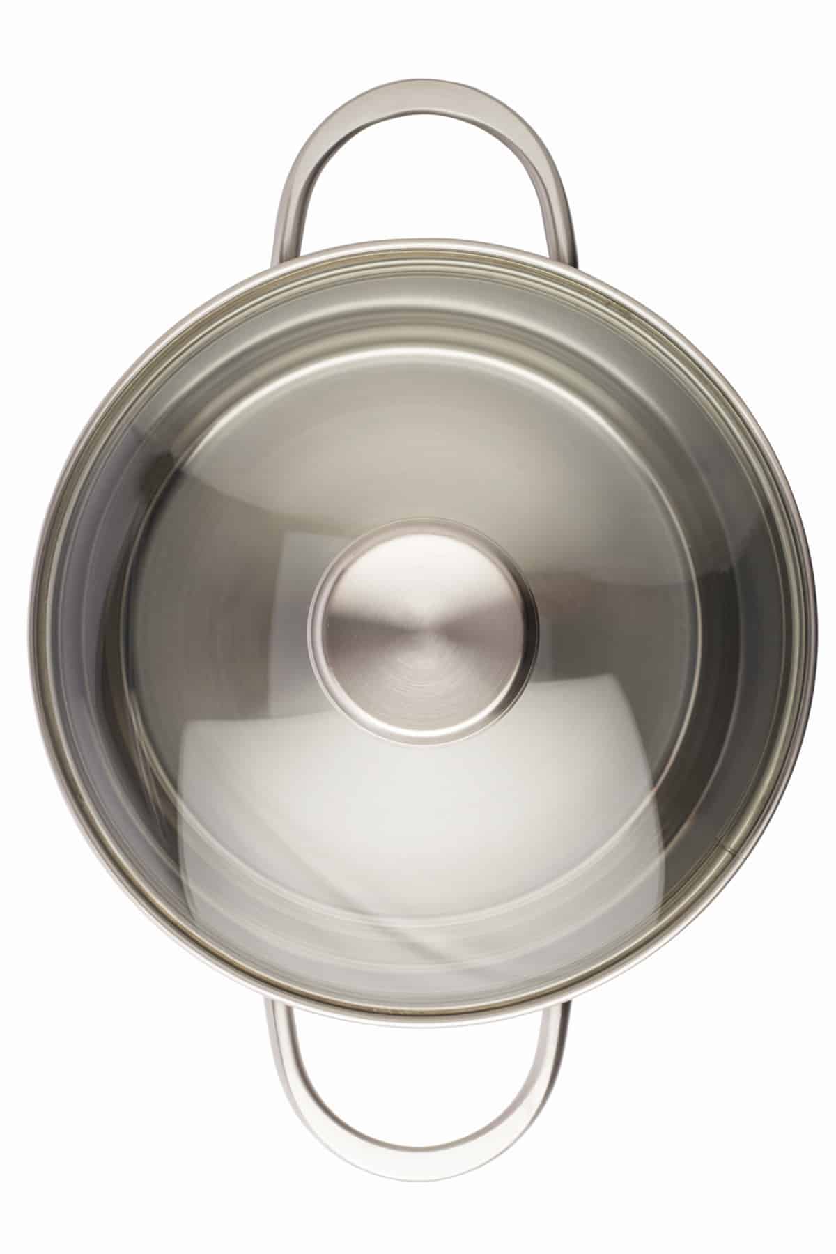Overhead view of stainless steel pot with glass lid.