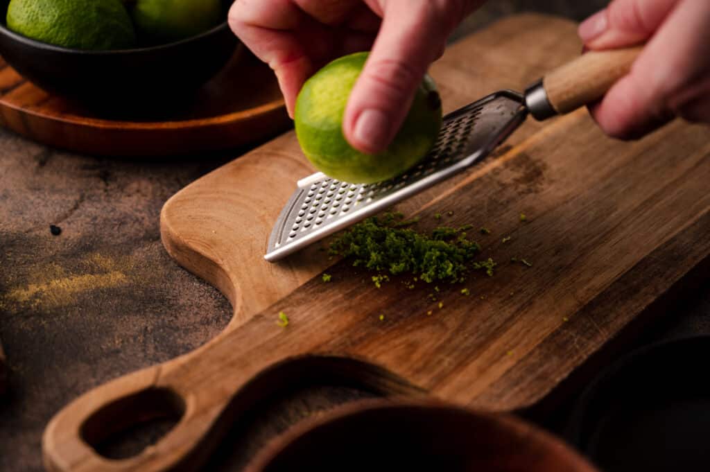 Zesting a lime with a citrus microplane.