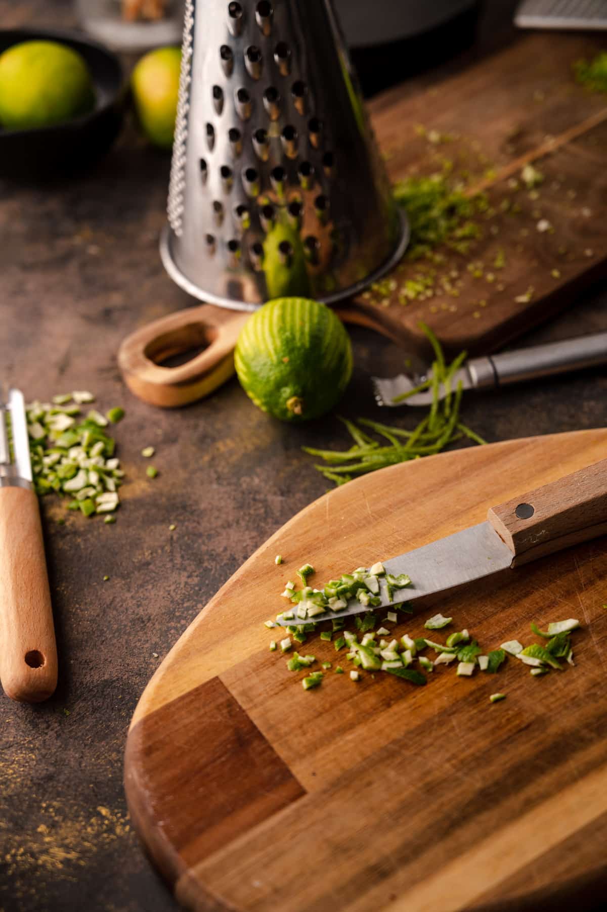 Wooden cutting boards with remains of a lime that has been zested.