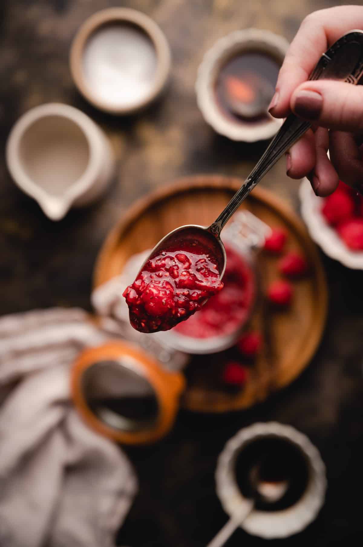 Vibrant raspberry jam on a spoon.