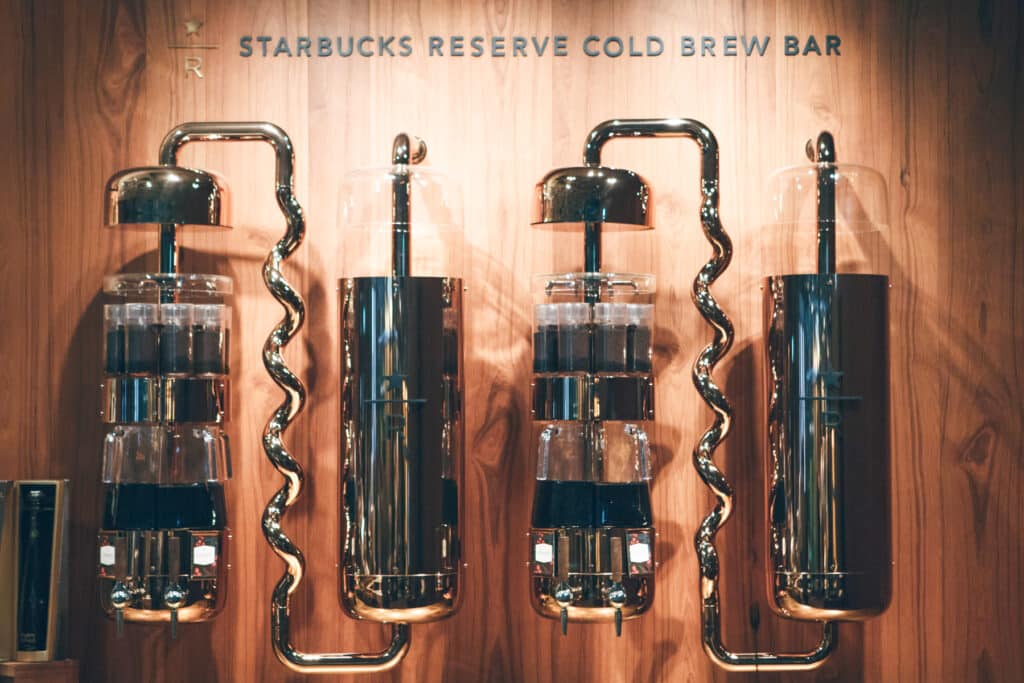 Starbucks Reserve cold brewing bar with wooden wall and glass coffee makers
