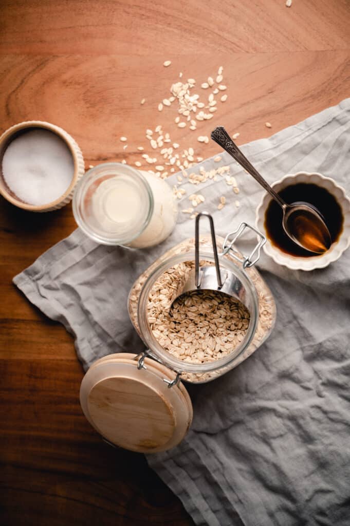 Ingredients for creamy oatmeal on a wooden table.