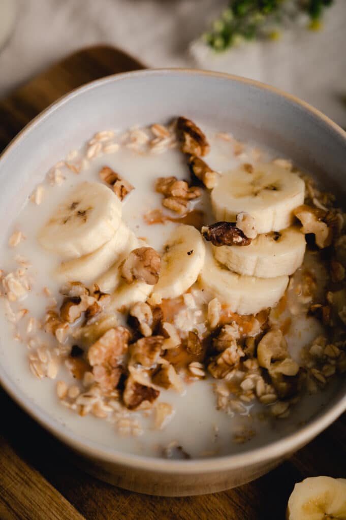 Close up of old fashioned banana walnut oatmeal on a wooden board.p