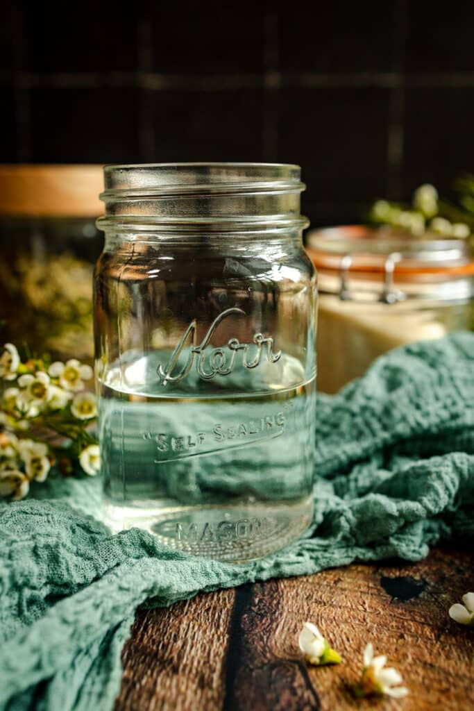 Pint sized Kerr mason jar filled part way with water.