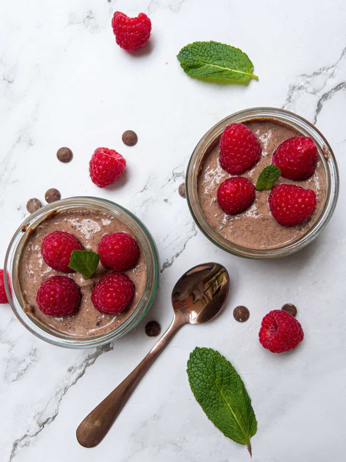 Vegan chocolate mousse with raspberries and mint.