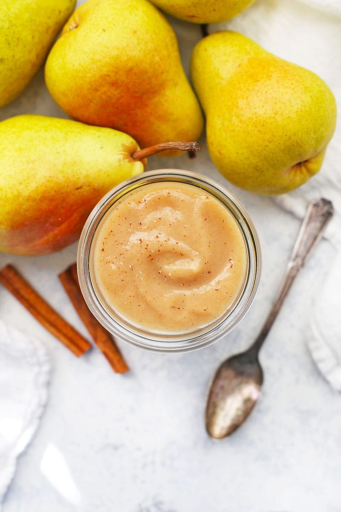 A vegan jar of pear sauce infused with pears and cinnamon.