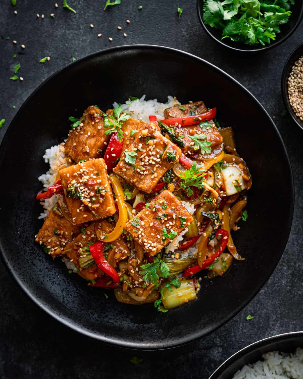 A vegan stir fry recipe featuring tofu and vegetables served over rice.