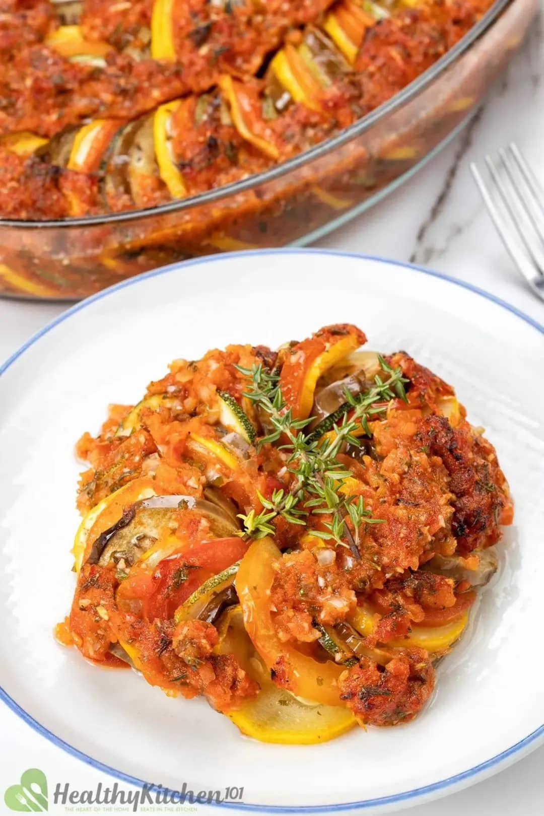 A plate of stuffed zucchini with tomato sauce and thyme from 60 Vegan Casserole Recipes.