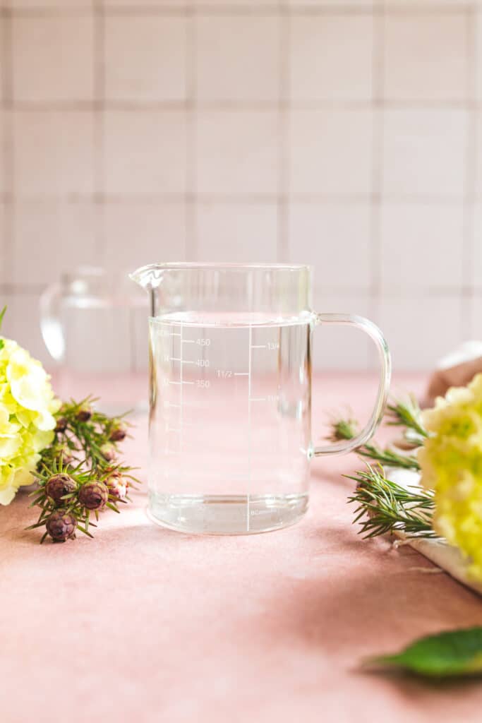 Half liter clear glass measuring cup with a white tile background.