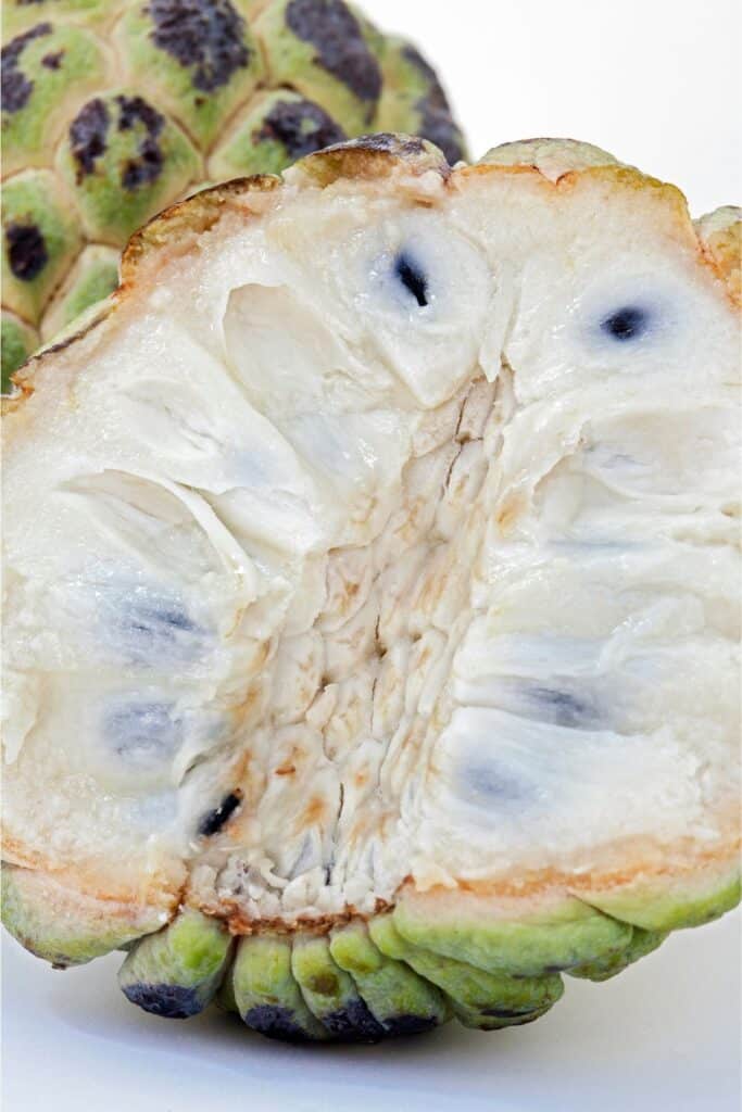 Inside flesh and seeds of a sweetsop fruit.