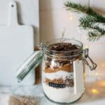 Homemade cookie ingredients in a glass jar with label.