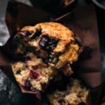 Close up of a blueberry muffin with a bite taken out of it.