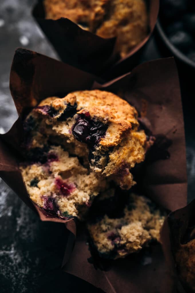 Close up of a blueberry muffin with a bite taken out of it.