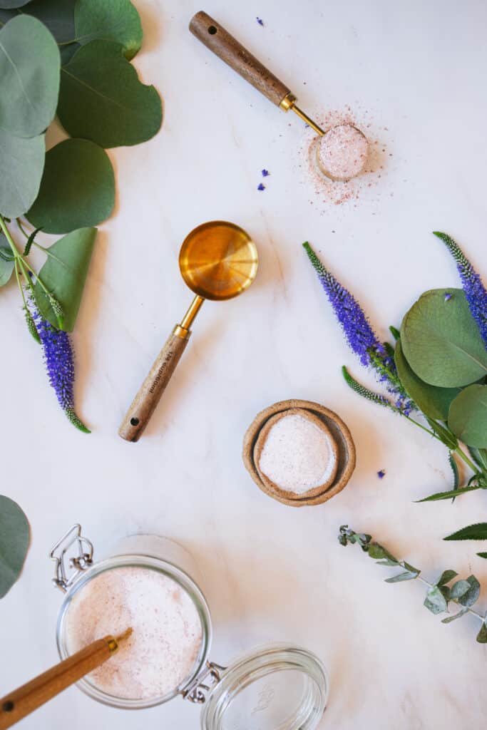 Flatlay of gold measuring spoon and 1/4 cup.