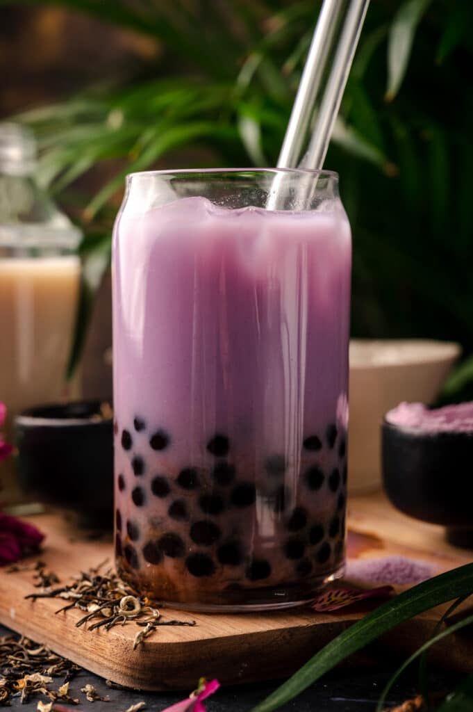 Close up of taro milk tea in a clear glass.