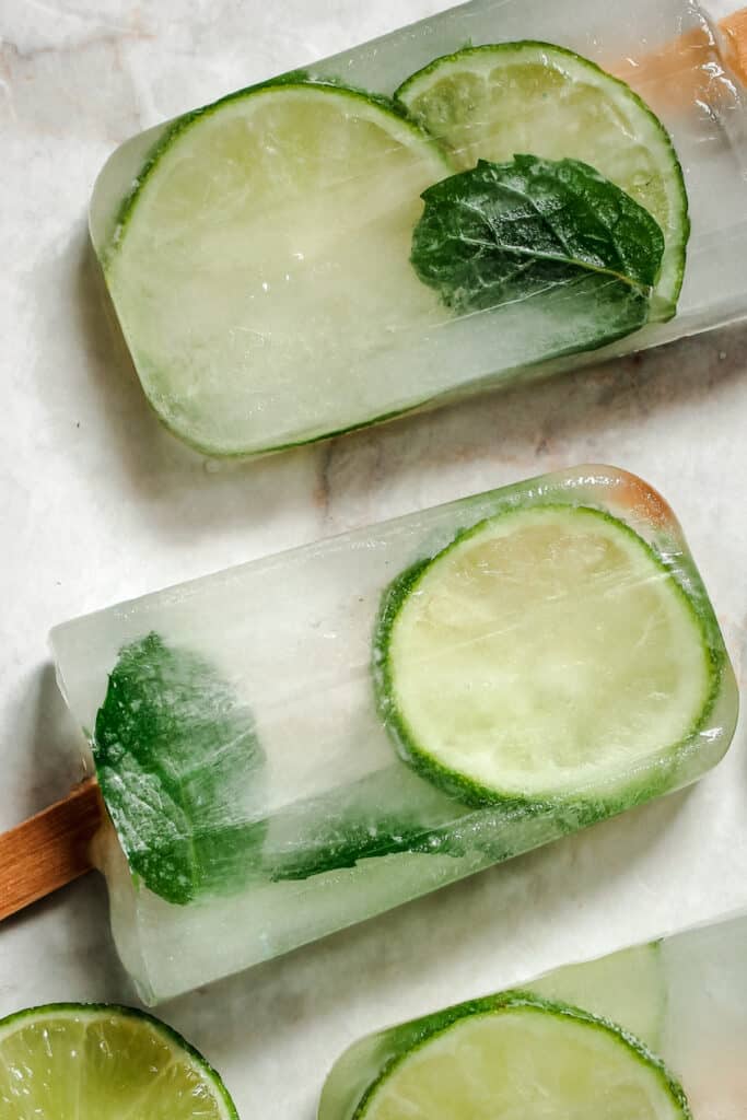 Popsicles with lime slices and mint leaves.