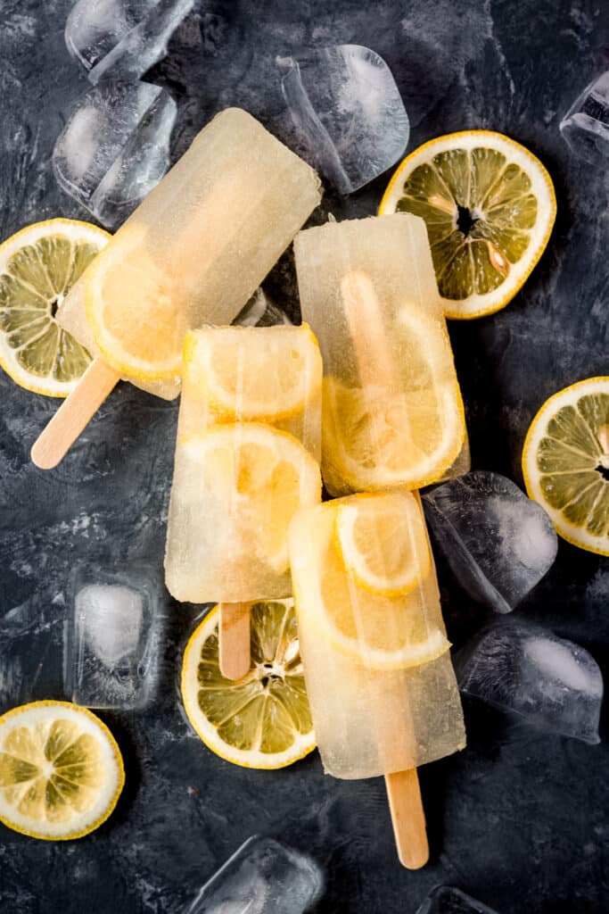 A group of popsicles with lemon slices on them.