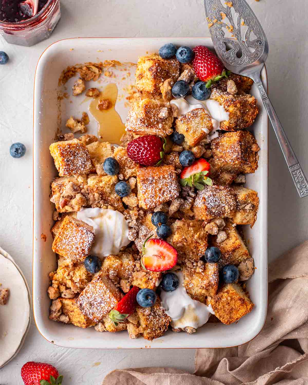 French toast casserole with berries and whipped cream.
