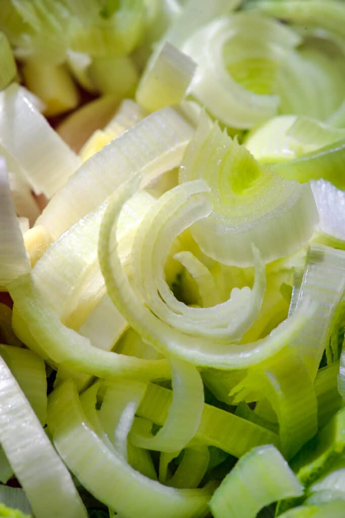 A close up of sliced leeks in a bowl.
