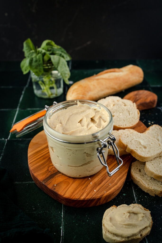 Cashew ricotta cheese spread on a piece of bread.