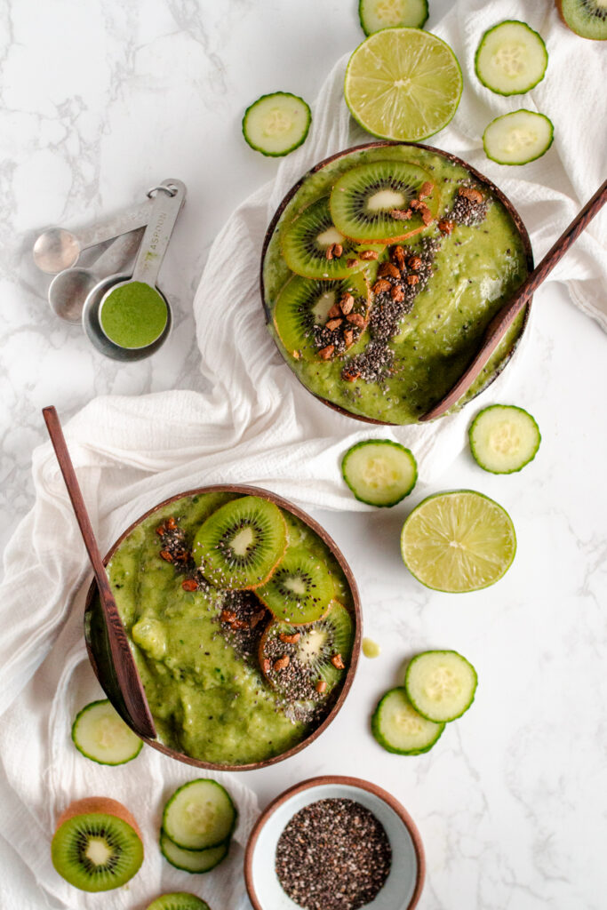 Two bowls of green smoothie with kiwi and chia seeds.