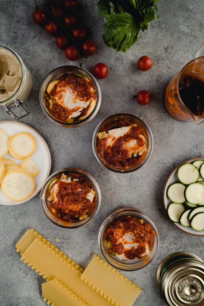Step-by-step-photo of homemade mini lasagna made in a jar.