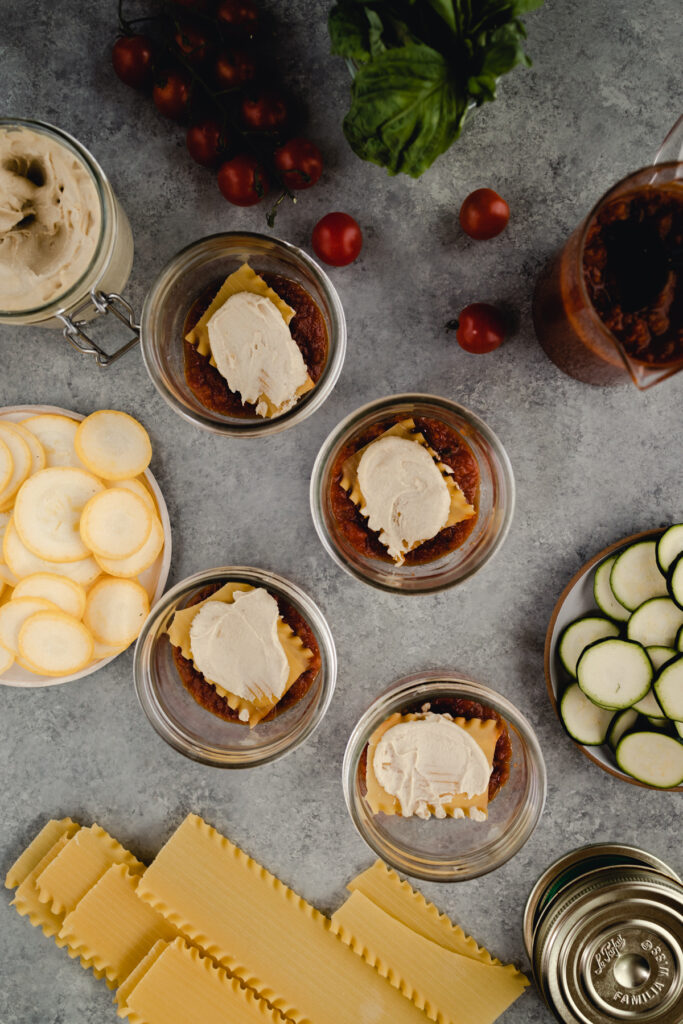 Step-by-step-photo of homemade mini lasagna made in a jar.