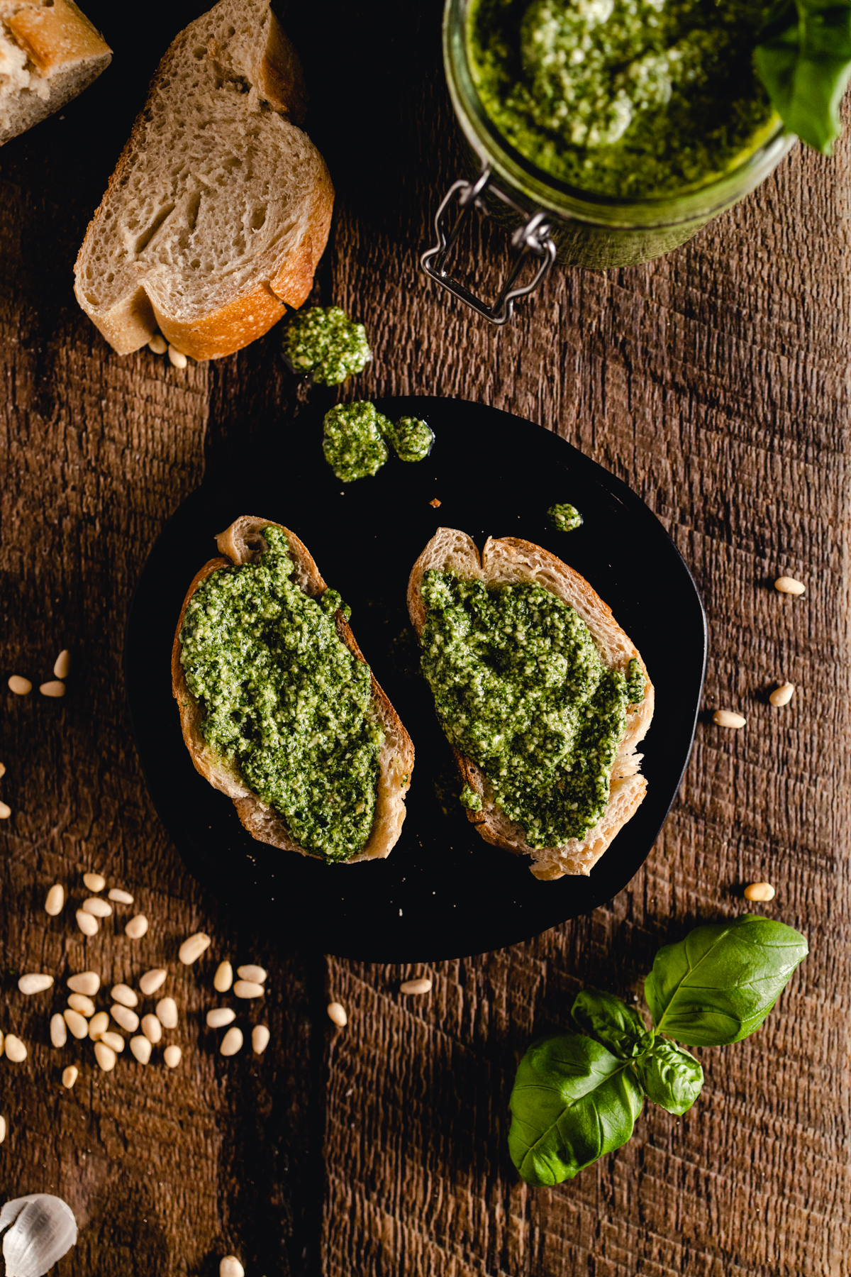 A plate with bread and pesto on it.