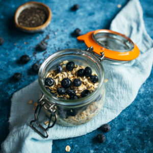 Oats in a glass jar with blueberries.