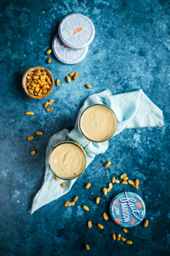 Peanut butter in a jar on a blue background.