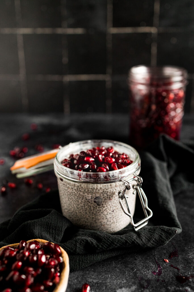 Pomegranate seeds and chia seeds in a jar.